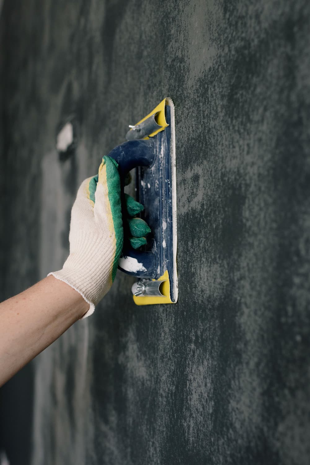 Hand troweling Venetian plaster onto a wall